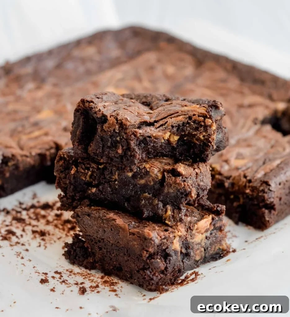 Three chocolate sourdough peanut butter brownies stacked on top of each other.
