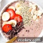 close up strawberry banana smoothie bowl