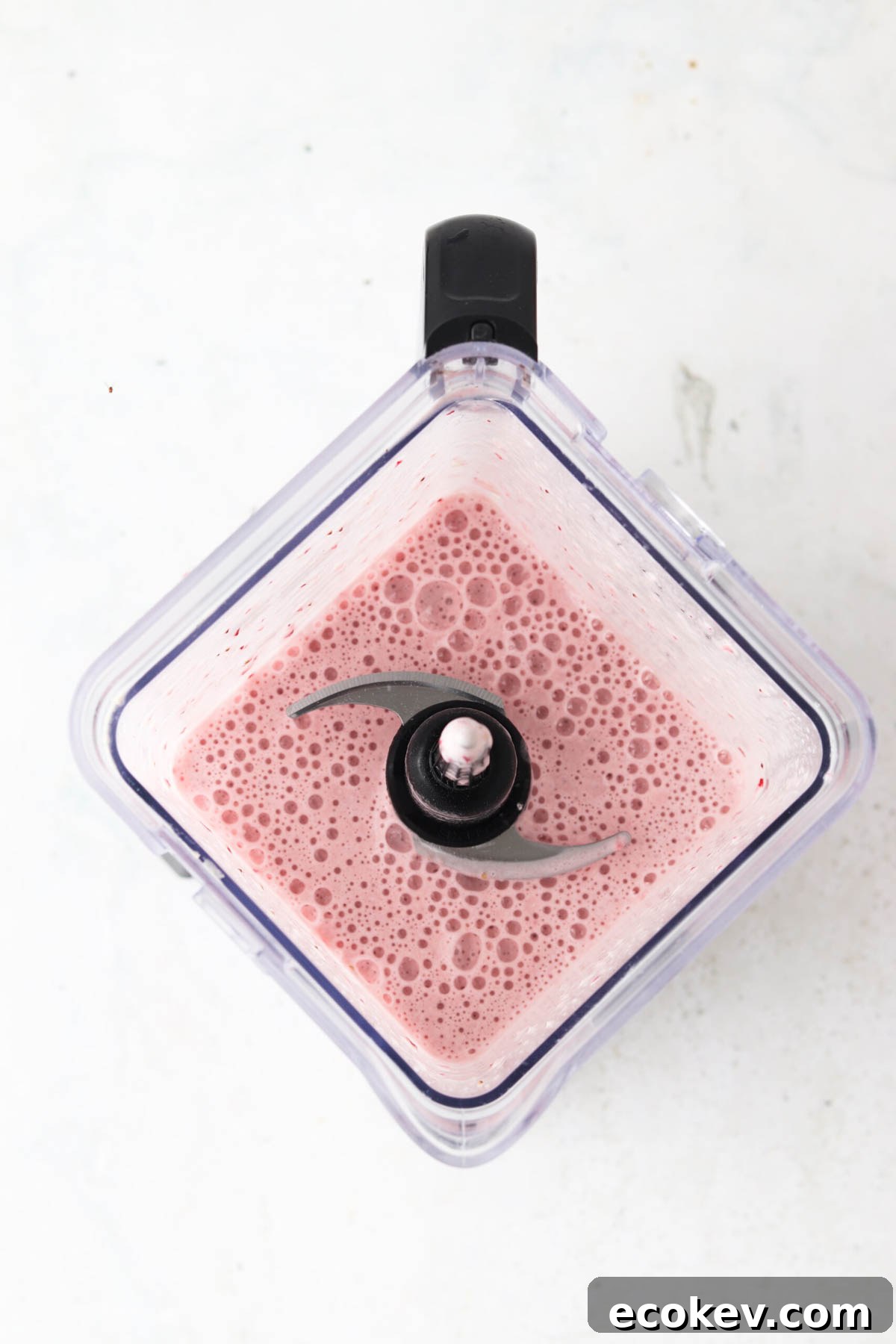 Blended up strawberry smoothie in a food processor. 