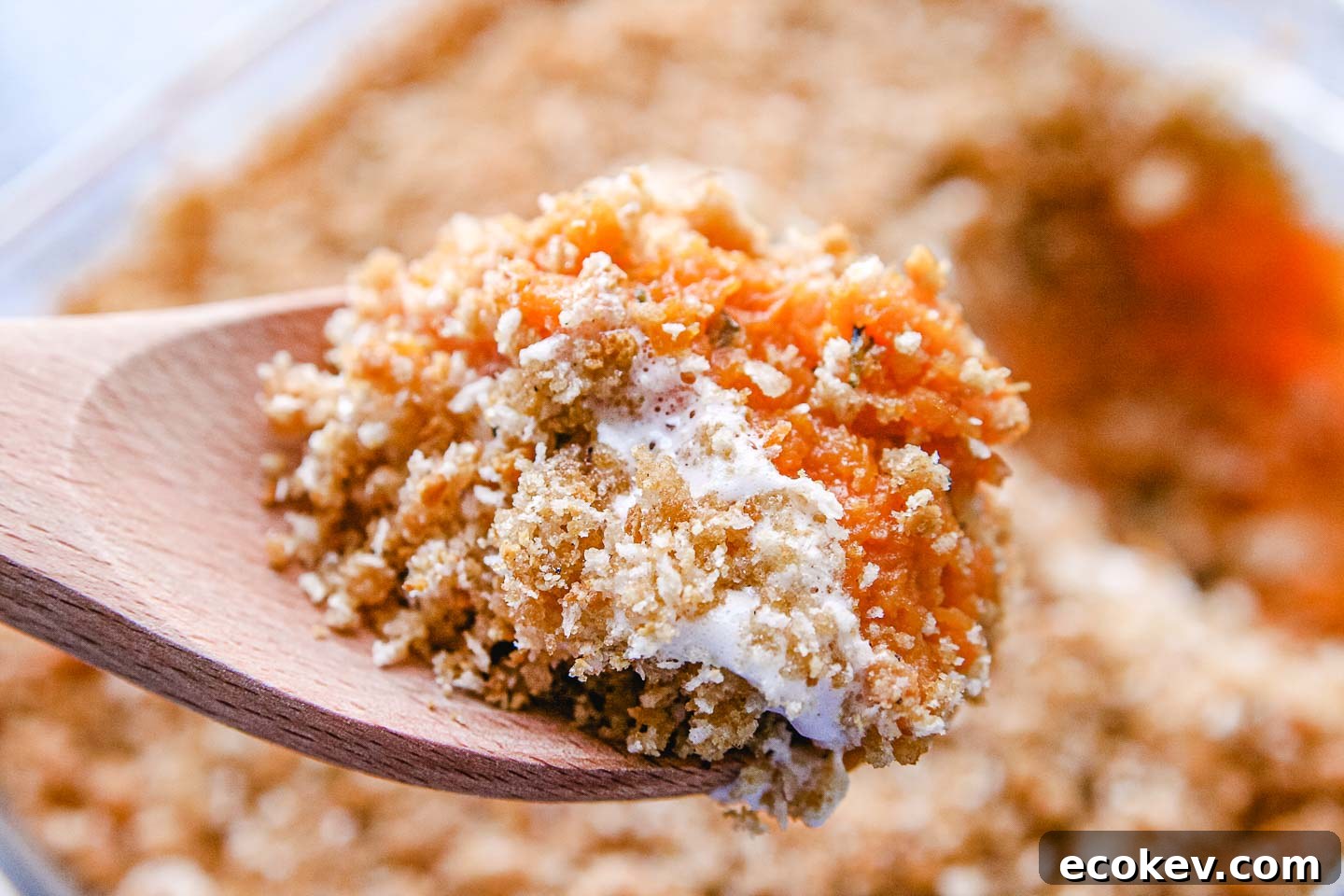 A scoop of sweet potato casserole on a spoon.