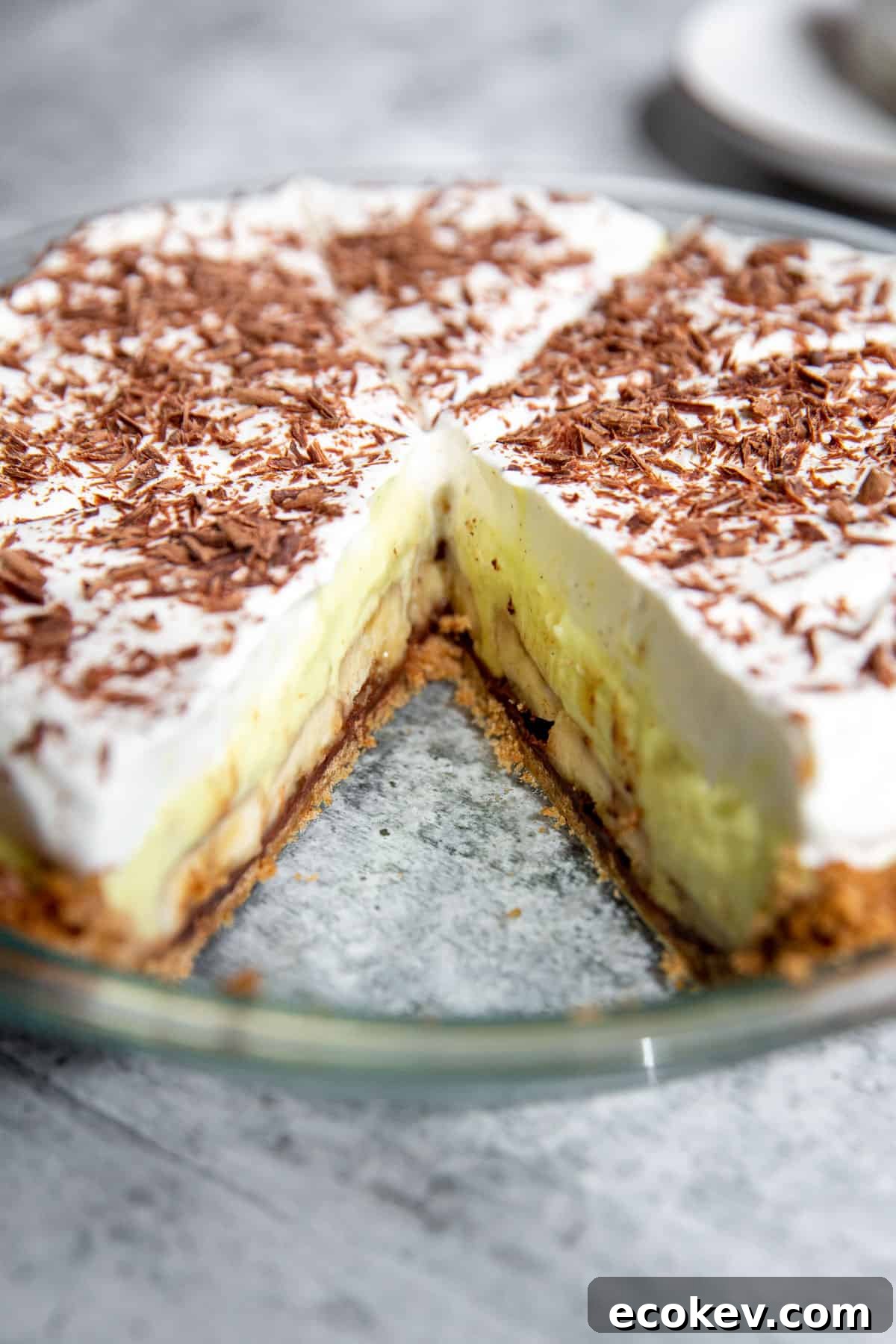 an upclose shot showing the banana cream pie with a slice take out