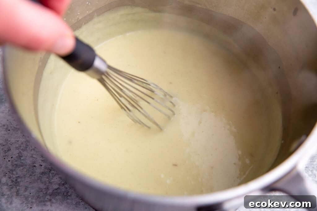 whisking the custard in a saucepan