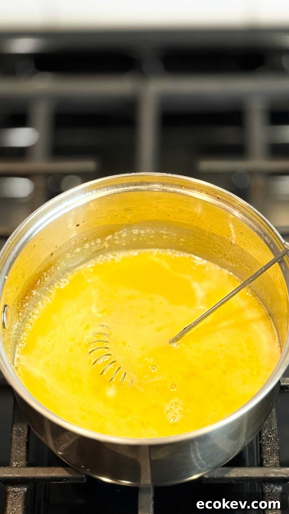 In pot on stove with whisk.