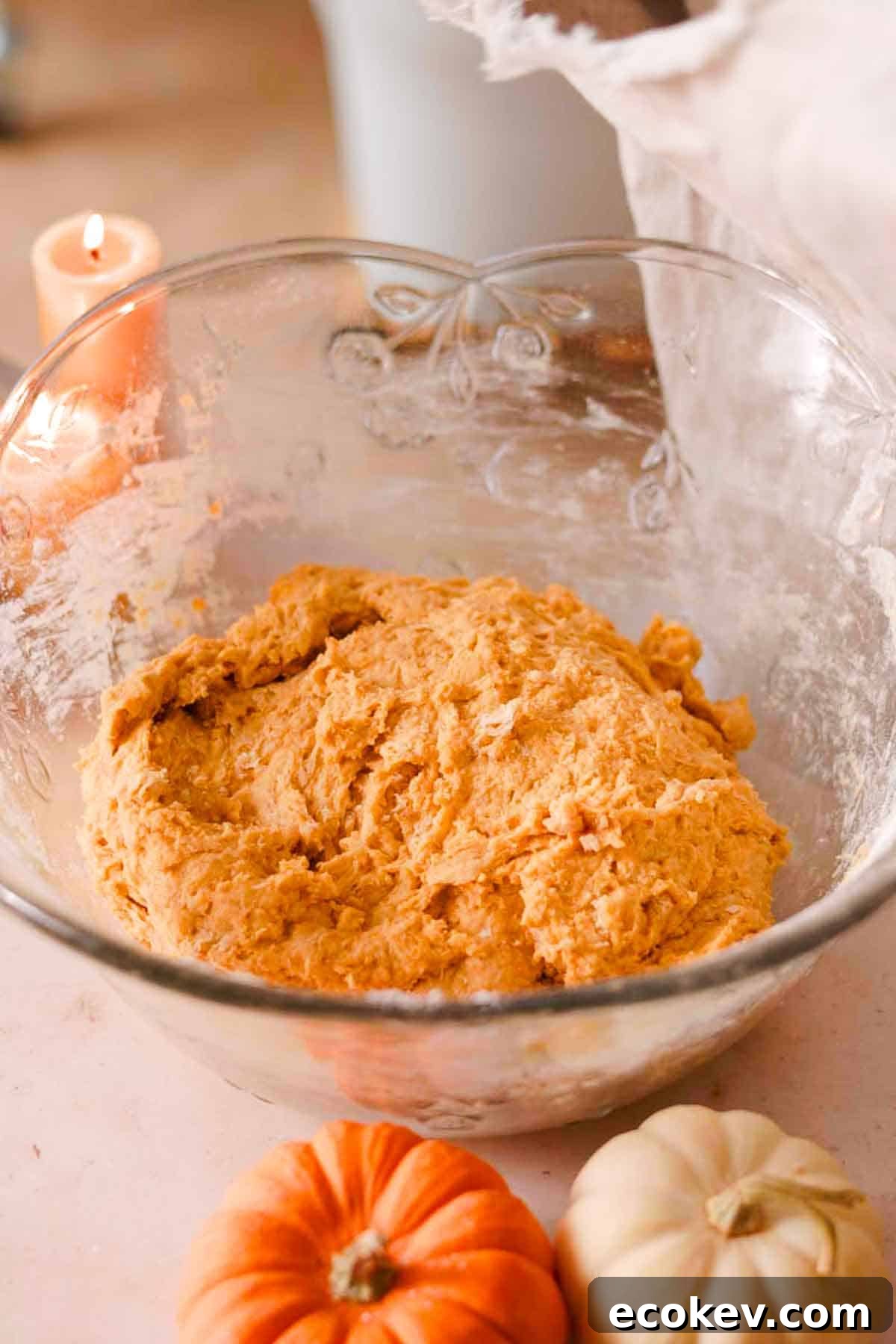 the mixed donut dough in glass bowl ready to rise