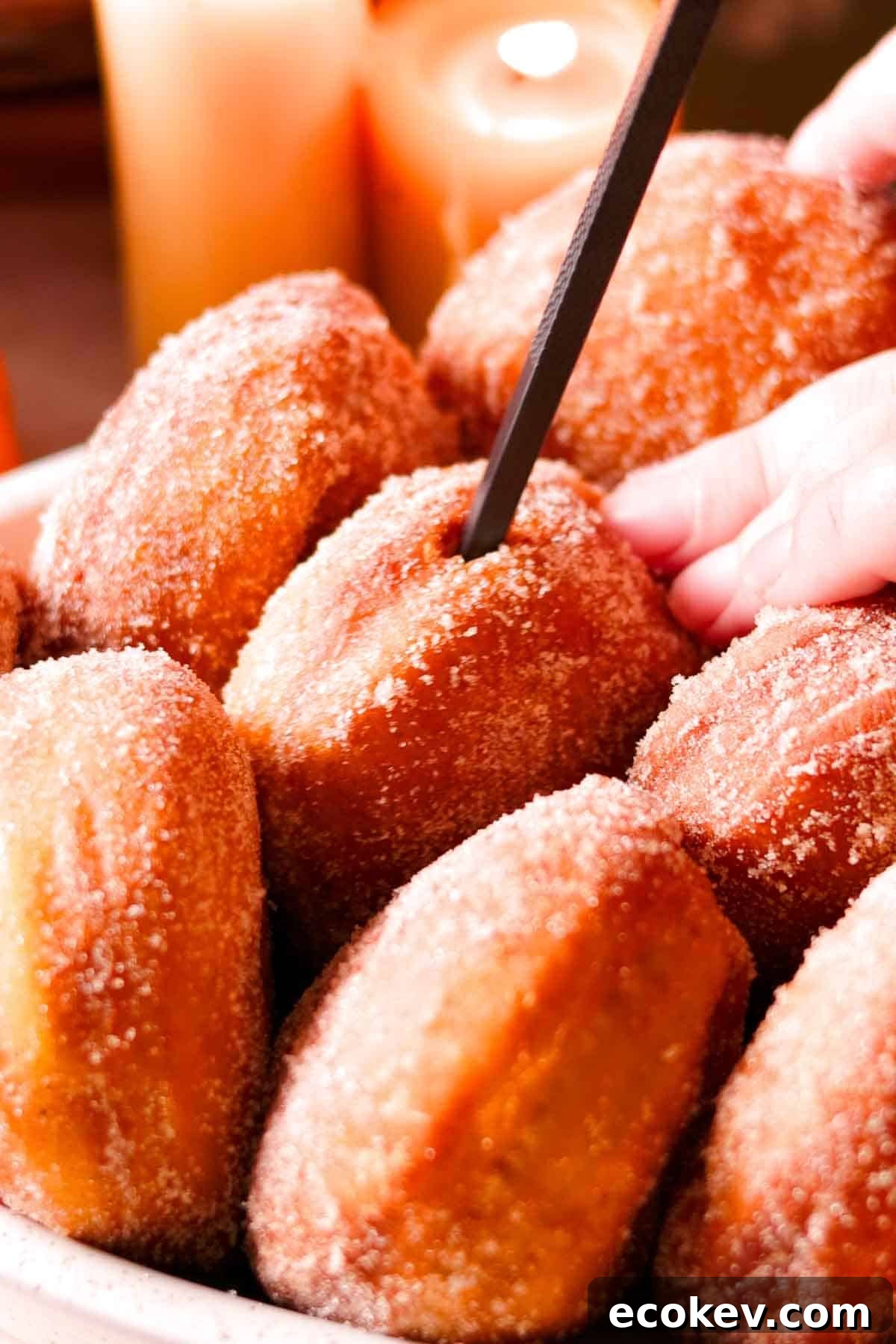 poking holes inside the fried and cooled donuts with a chopstick