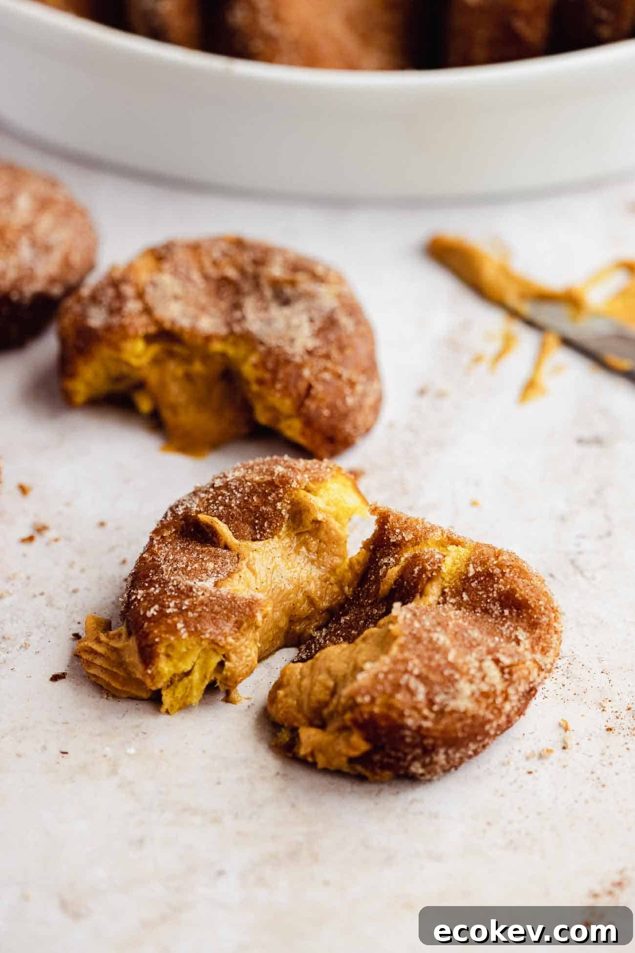 torn apart pumpkin spice donut with filling coming out