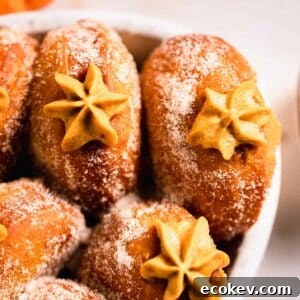 pumpkin donuts with piped filling peaking out in casserole dish