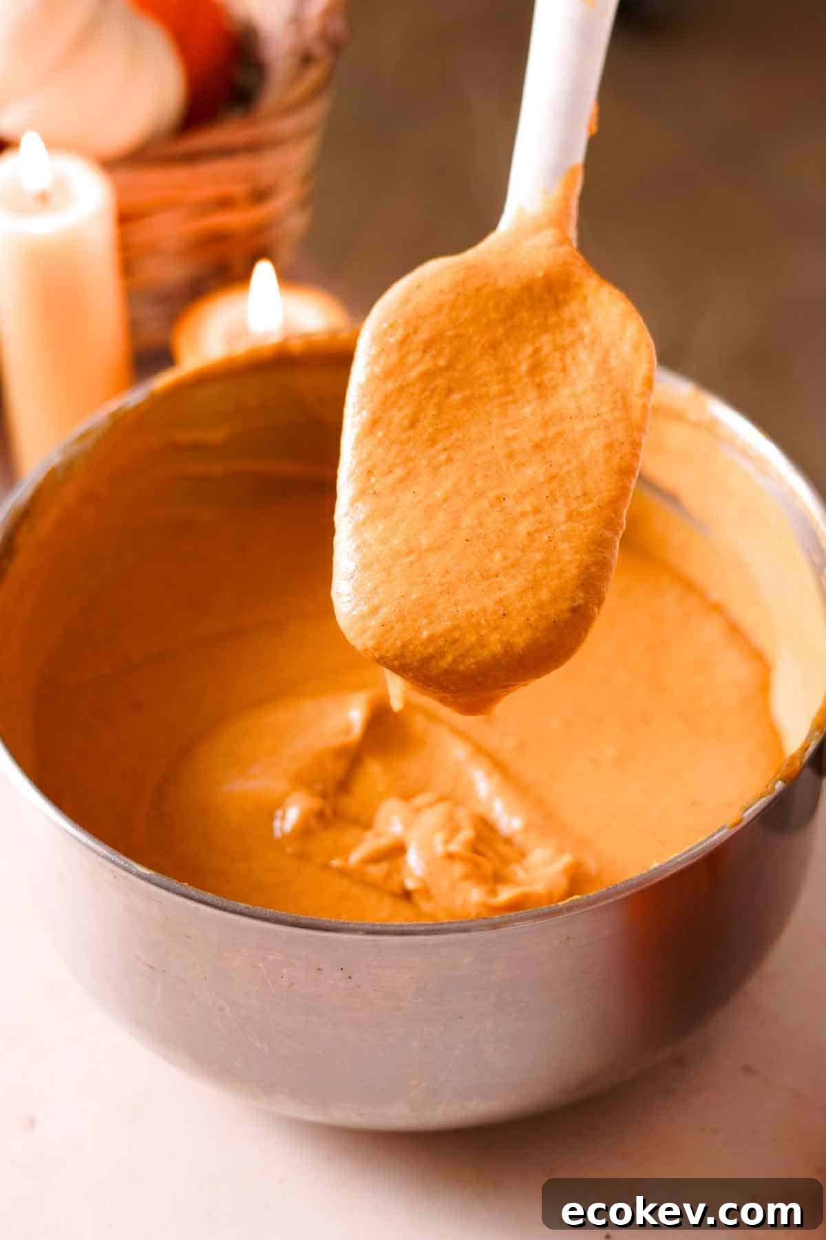showing the thickened consistency of pumpkin custard on a rubber spatula