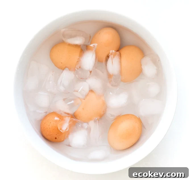 adding cooked eggs to water bath