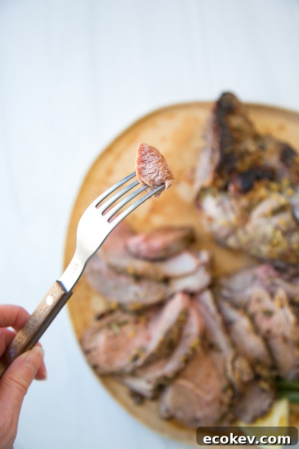 fork holding a bite of lamb leg