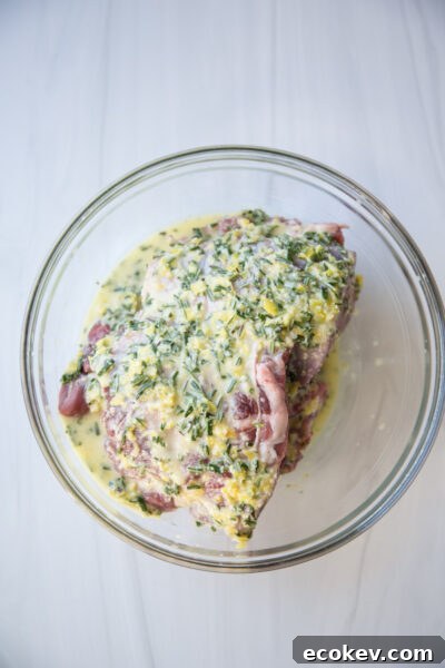 boneless leg of lamb in a bowl with marinade