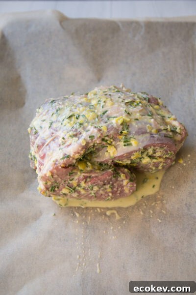 marinated boneless leg of lamb on a sheet pan before oven