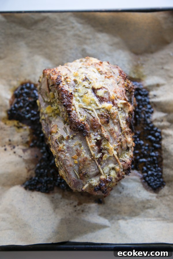 tied and roasted boneless leg of lamb on a sheet pan
