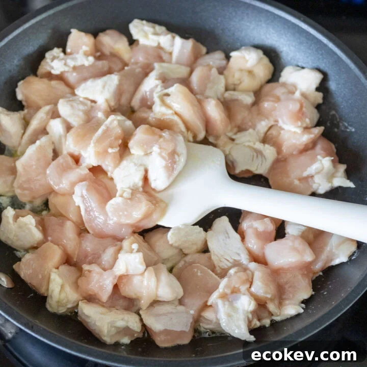 Pan frying cubed chicken breasts.