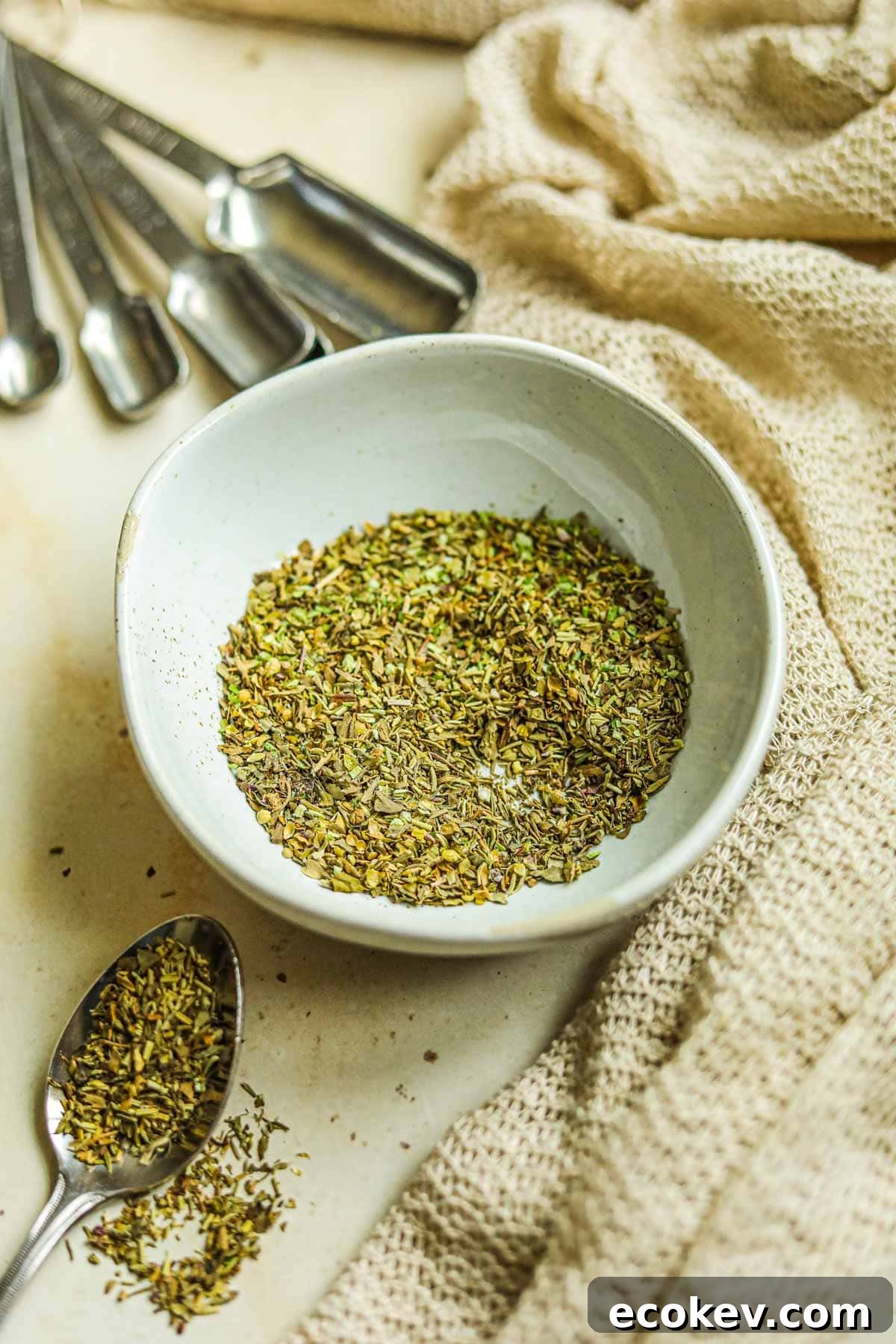 Italian seasoning substitute with dried basil, parsley, thyme, rosemary, and oregano in a bowl.