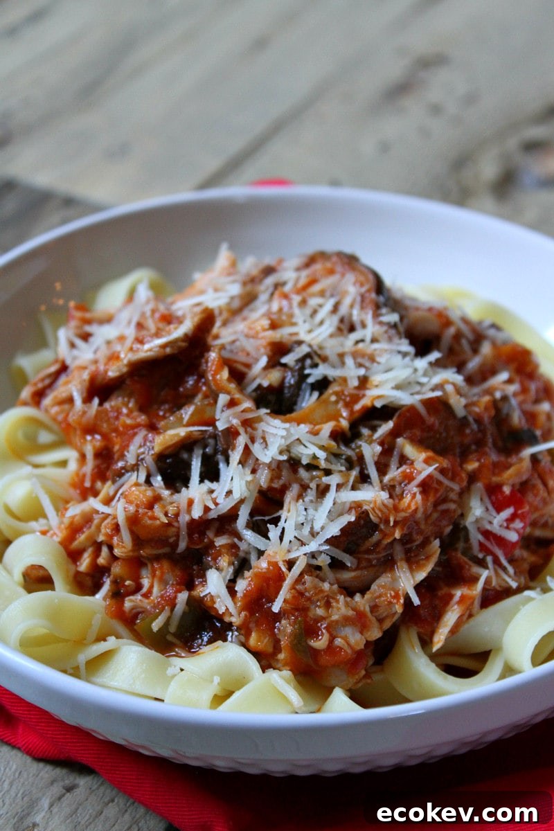 Slow Cooker Chicken Cacciatore served over noodles