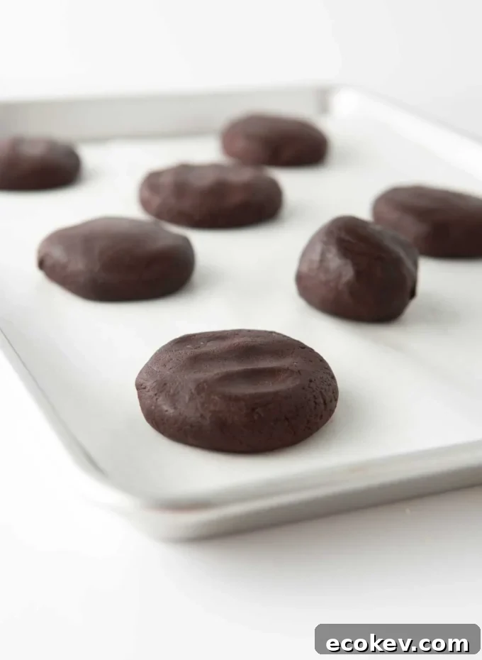 andes mint cookie dough balls slightly flattened on cookie tray