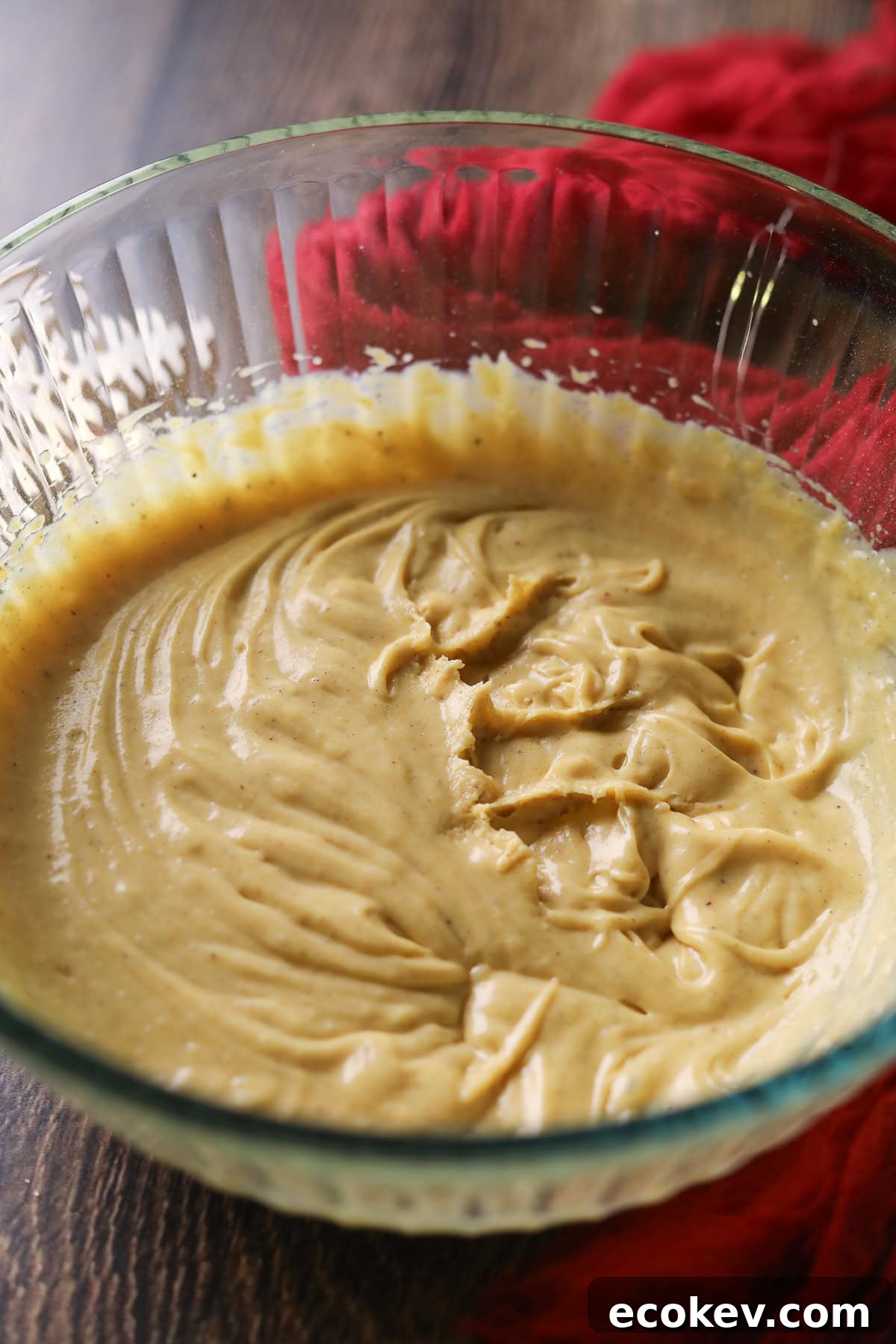 Putting an eggnog mixture in a mixing bowl for eggnog pie.