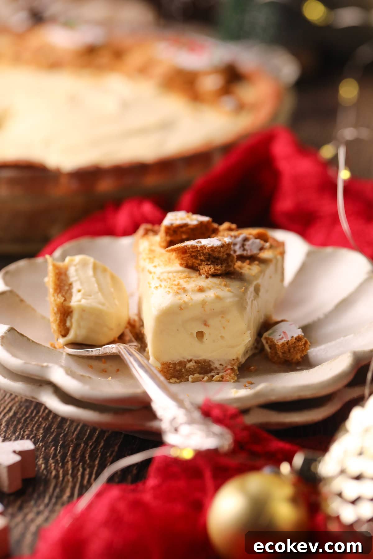Slice of eggnog pie on a white plate with a silver fork.