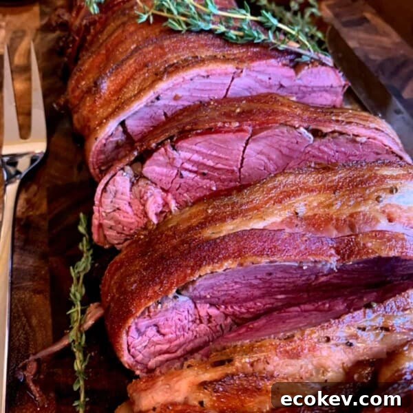 A smoked beef tenderloin, cooked medium rare and sliced.