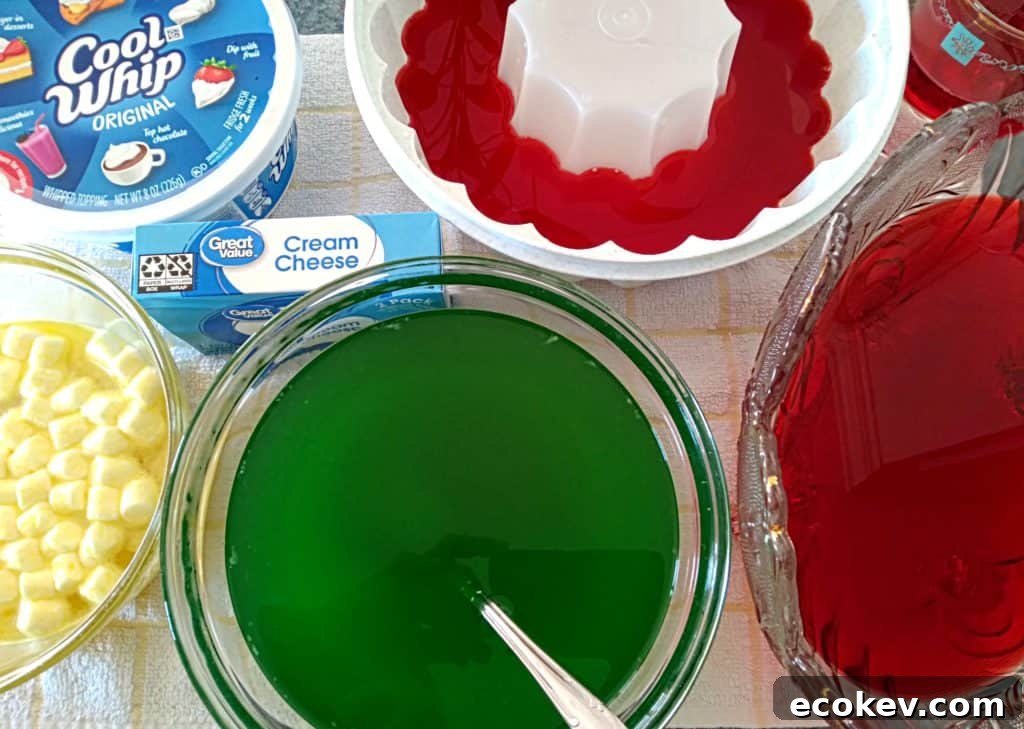 bowls of red and green jello and lemon jello with marshmallows