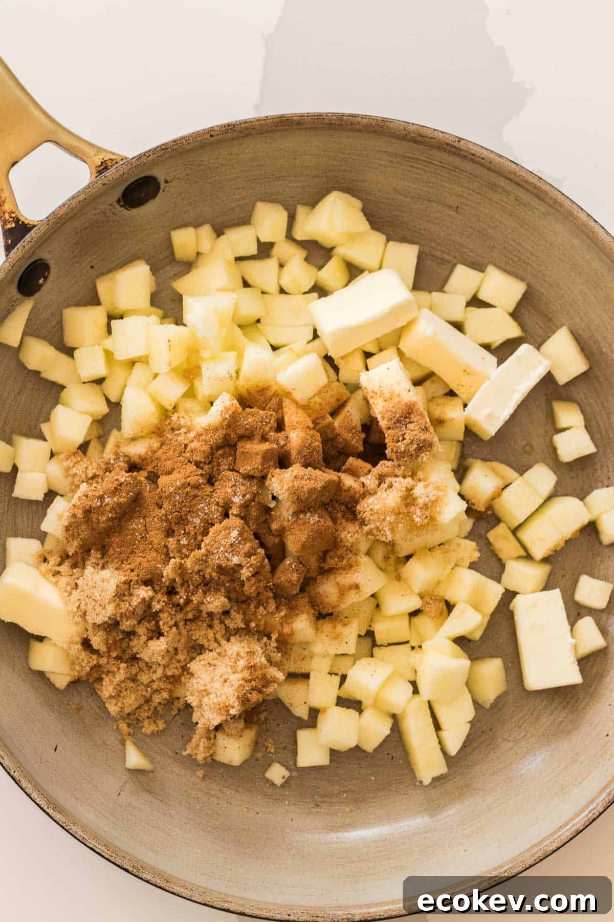 diced apples with butter, brown sugar and cinnamon in a saute pan