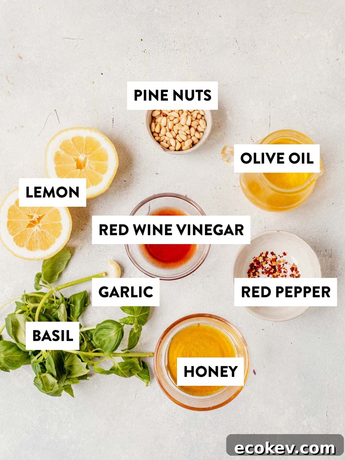ingredients for salad dressing portion of lemon basil orzo salad laid out on a counter and labeled