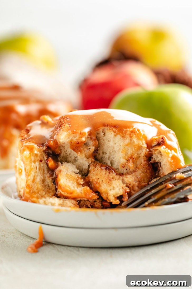 Inside view of a cinnamon roll with caramel sauce.