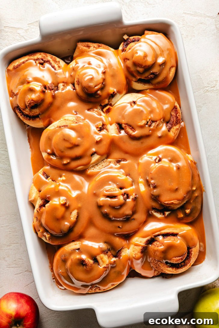 Overhead view of fall flavored cinnamon rolls in a pan.
