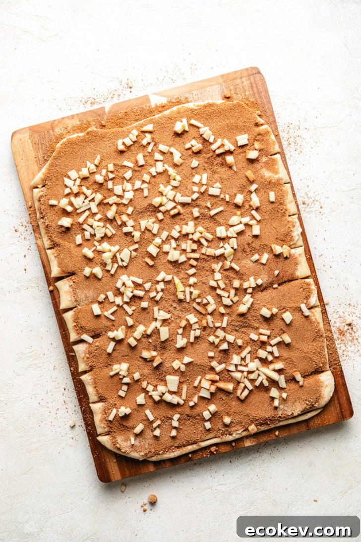 Dough with cinnamon sugar and apples.