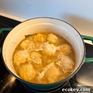 Dumplings and heavy cream in a pot.