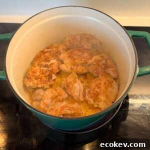 Chicken searing in a dutch oven.