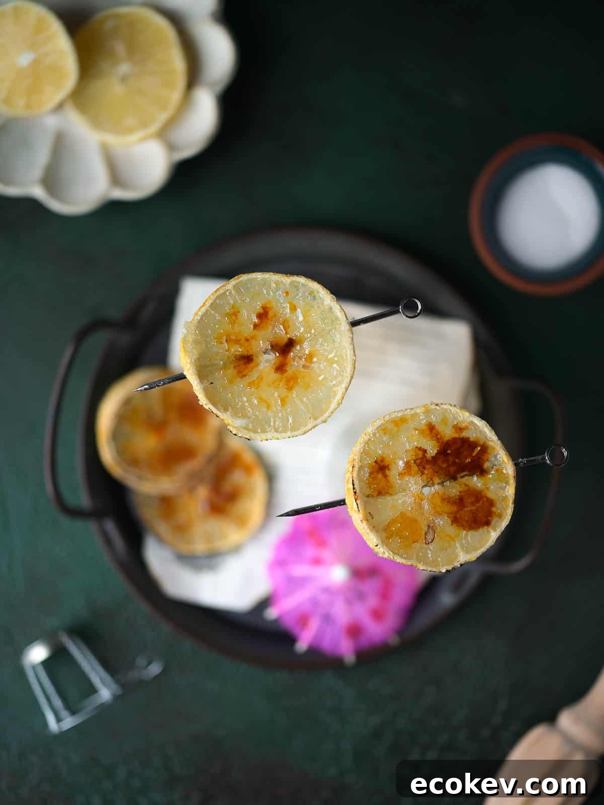 Overhead view of bruleed lemon slices on top of glasses.