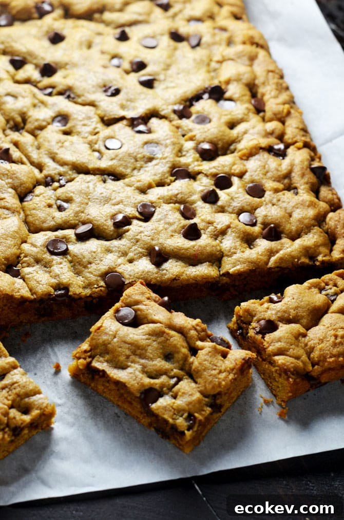 Pumpkin Chocolate Chip Cookie Bars. Perfect for fall and winter, these soft, pumpkin spiced desserts are a hit, and easy to make from scratch! | hostthetoast.com