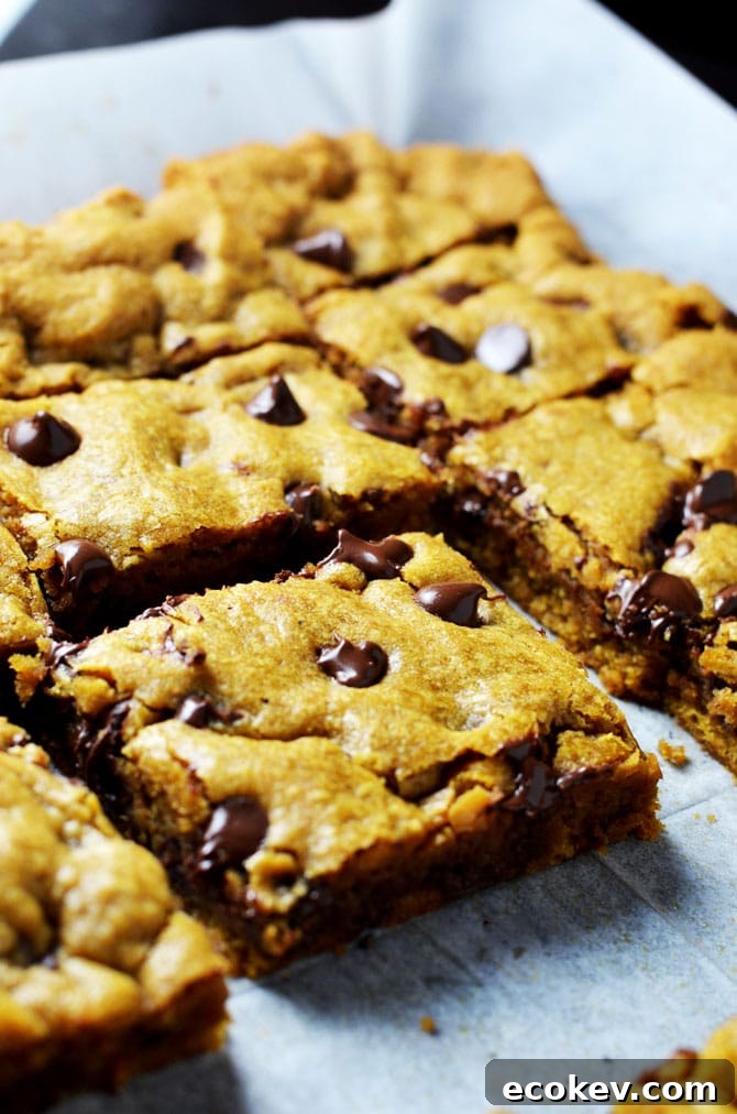 Pumpkin Chocolate Chip Cookie Bars. Perfect for fall and winter, these soft, pumpkin spiced desserts are a hit, and easy to make from scratch! | hostthetoast.com