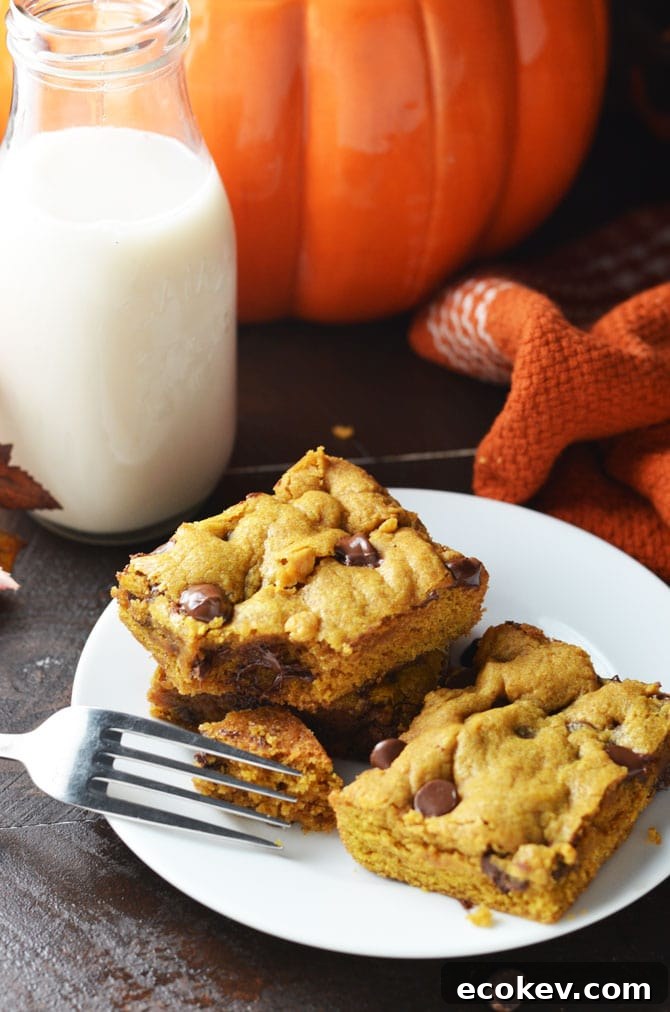Pumpkin Chocolate Chip Cookie Bars. Perfect for fall and winter, these soft, pumpkin spiced desserts are a hit, and easy to make from scratch! | hostthetoast.com