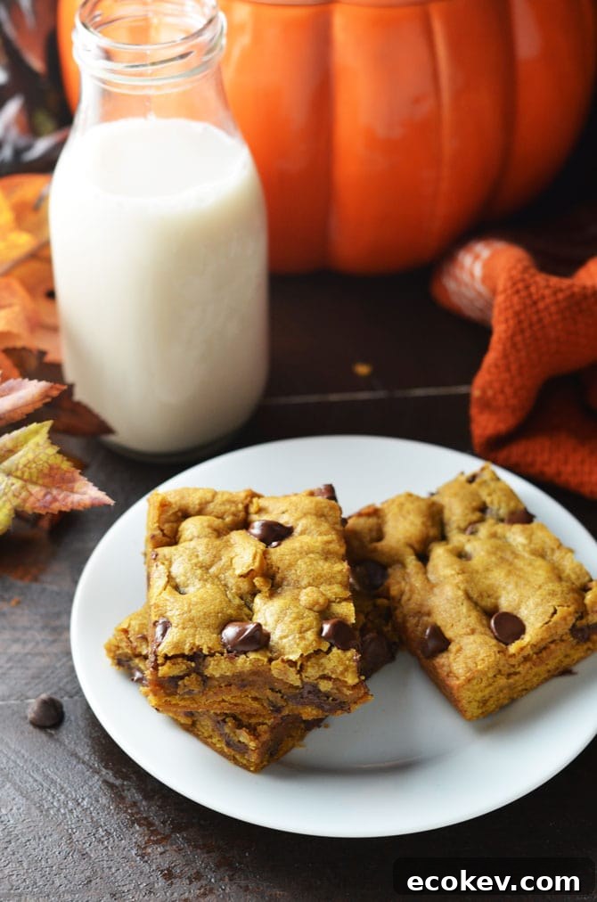 Pumpkin Chocolate Chip Cookie Bars. Perfect for fall and winter, these soft, pumpkin spiced desserts are a hit, and easy to make from scratch! | hostthetoast.com