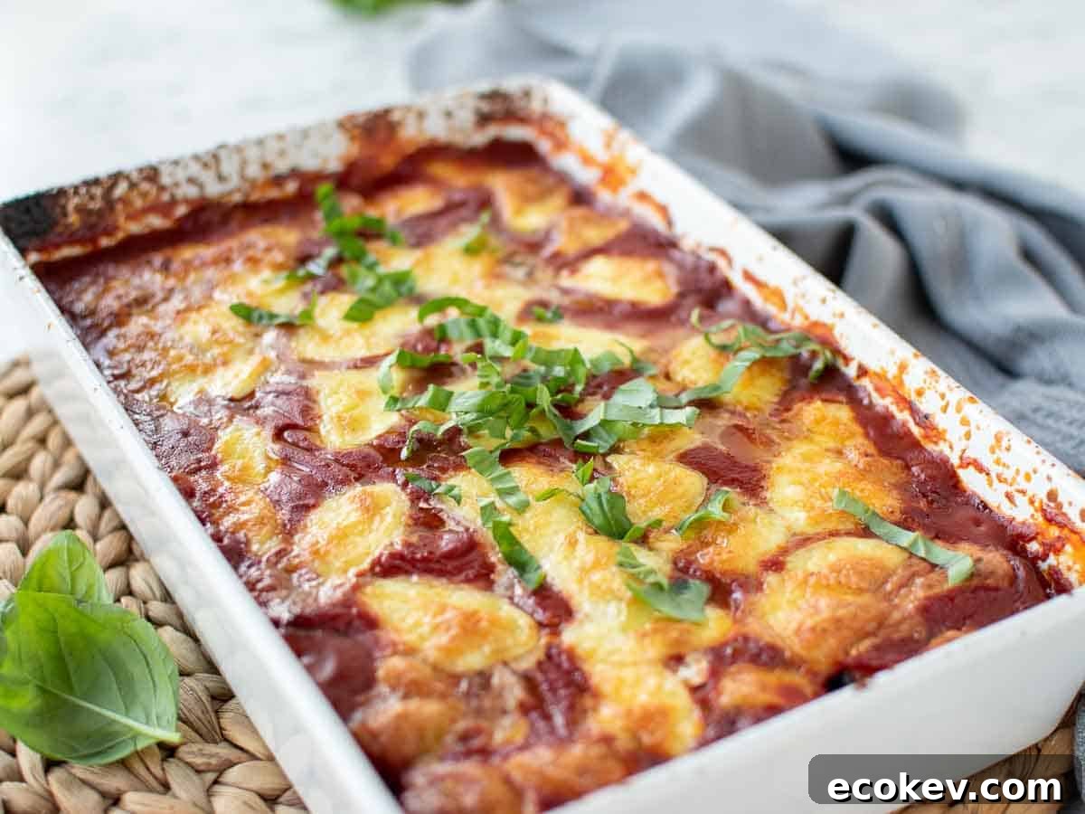 Baked tomato and cheese in a white baking dish.