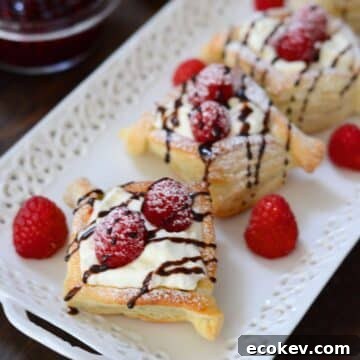 Raspberry danish served with fresh rapberries and dusted with powdered sugar.