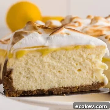A close up image of a piece of lemon meringue cheesecake.