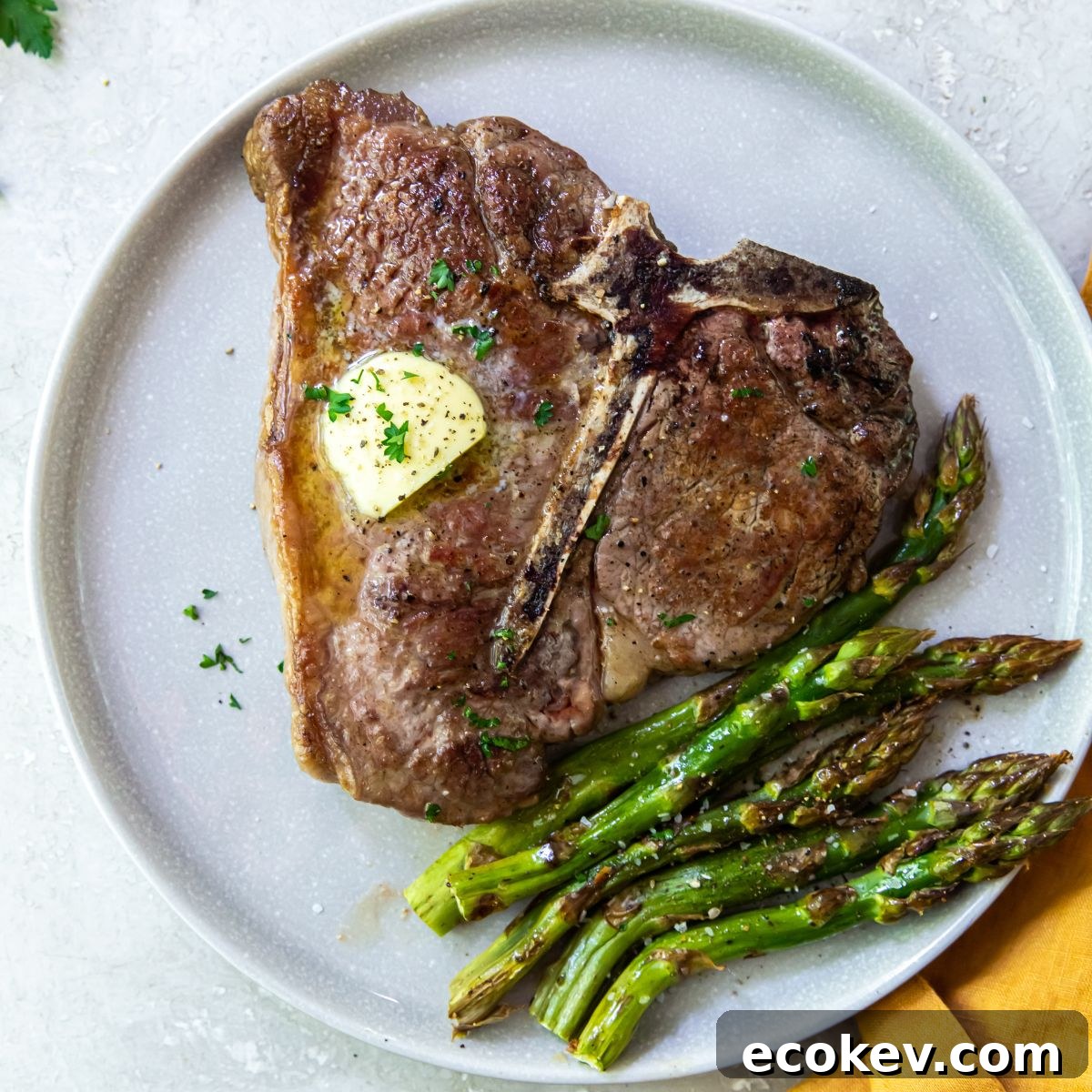 A plate with steak and asparagus on it.