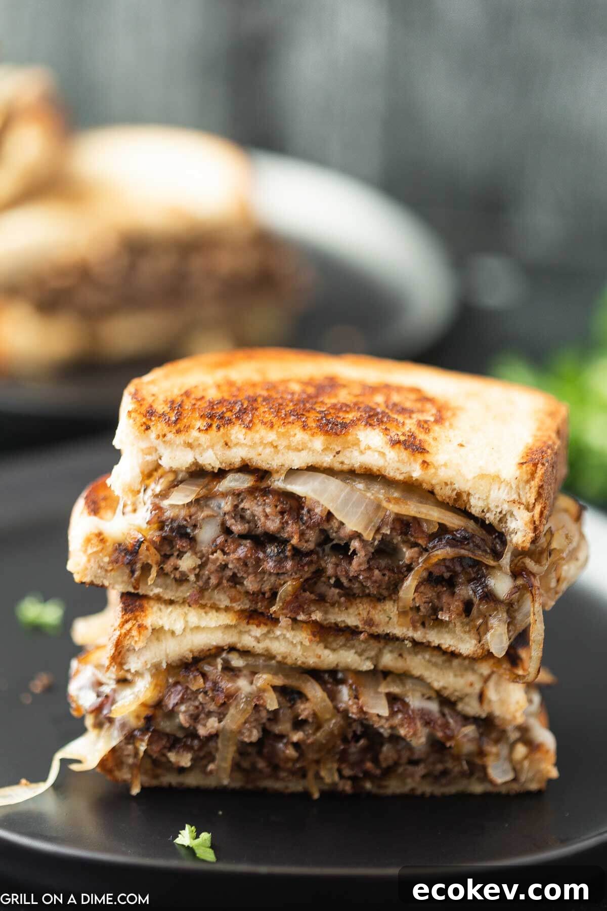 Patty Melt cut in half and stacked on a plate