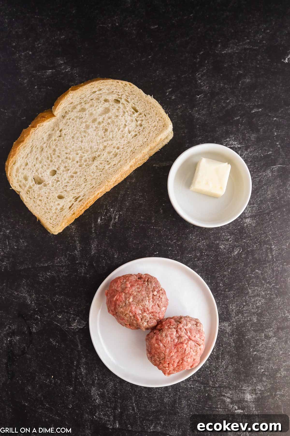 Slice of bread with a bowl of butter and a plate of two ground beef balls