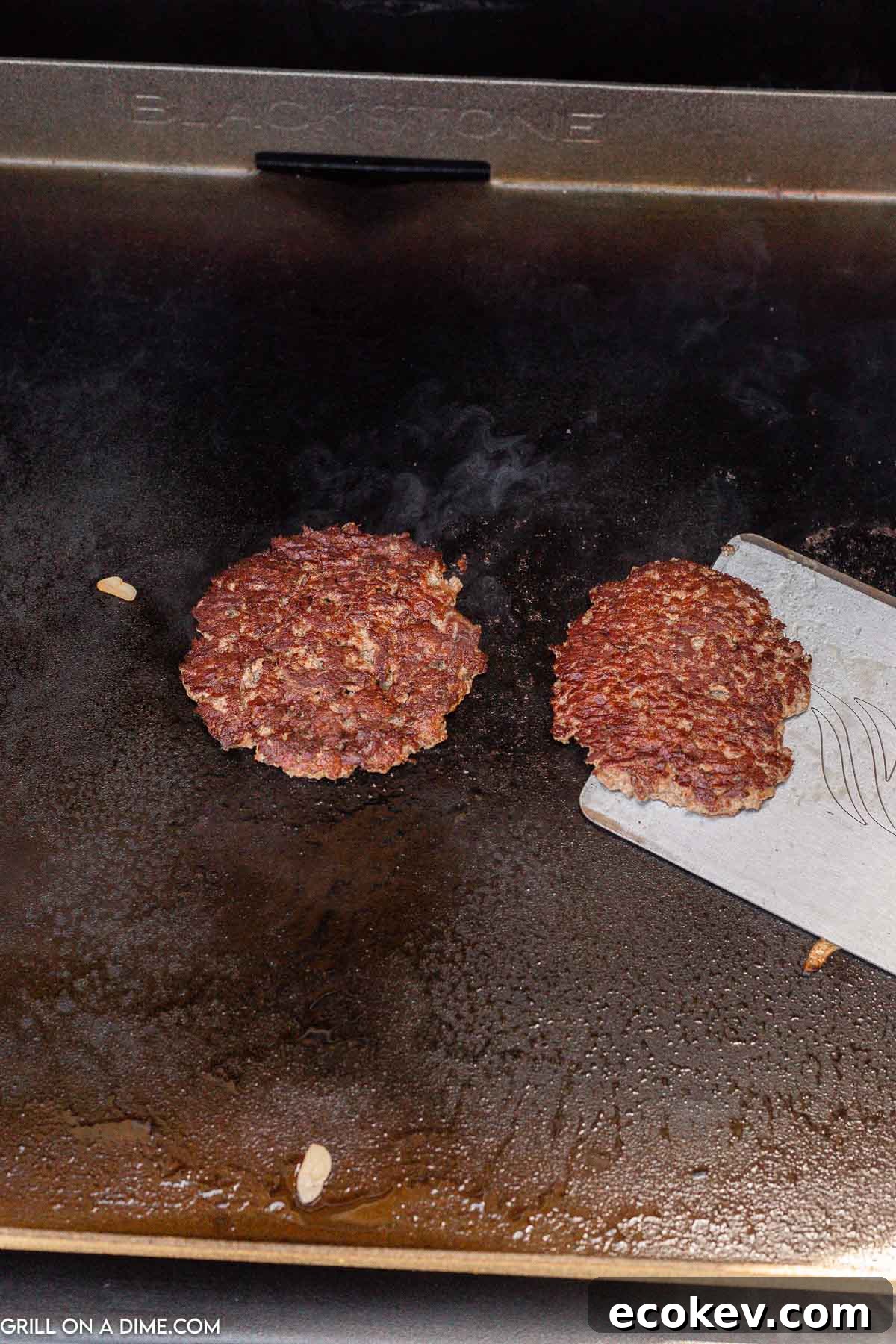 Cooked ground beef patty on the griddle