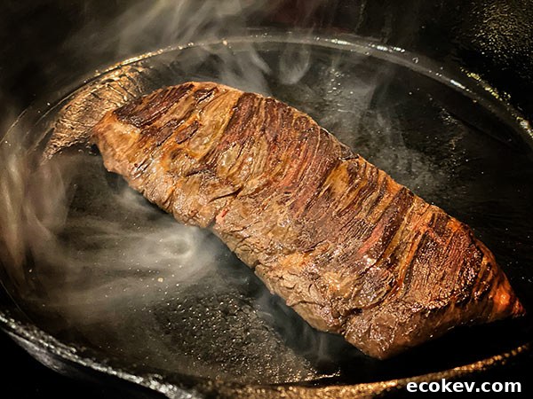 Pan searing skirt steak on a cast iron skillet