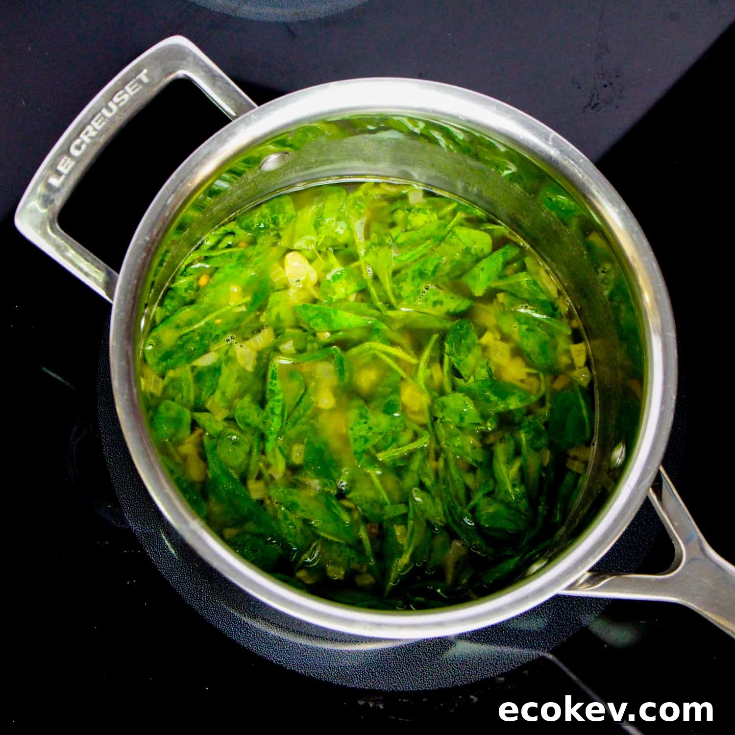 photo of making spinach and cannellini soup in a pan