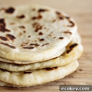 Sourdough Naan, after cooked, on a wooden board.