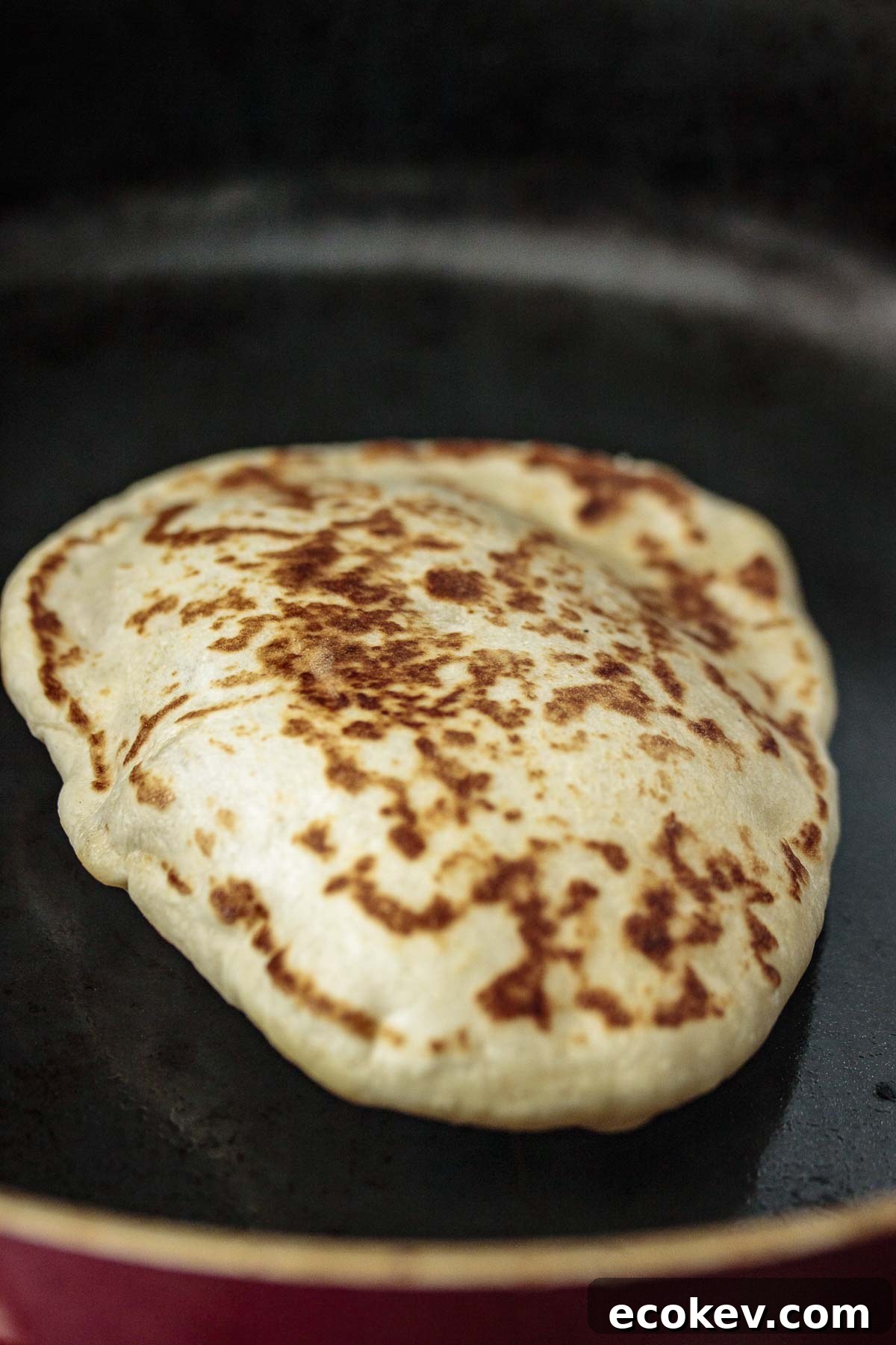 Puffing sourdough naan, while cooking.