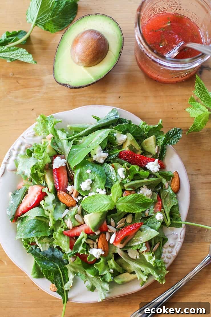 Baby Kale Salad with Strawberry-Mint Vinaigrette, goat cheese, walnuts, and avocado - a healthy and delicious summer salad recipe