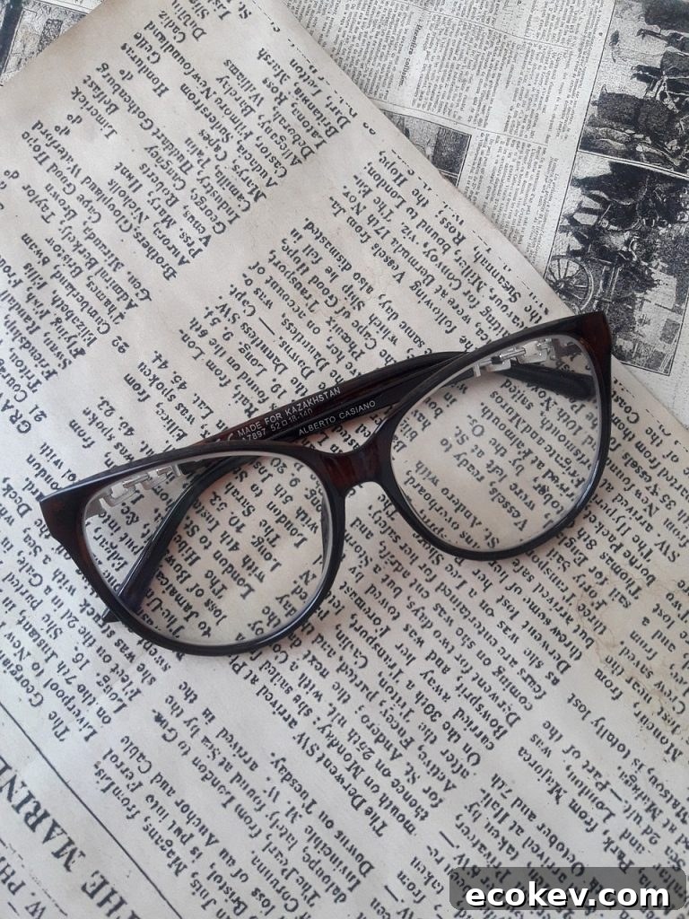 Black framed eye glasses on top of a newspaper